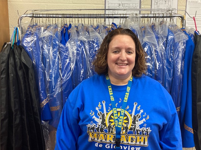 Monike Hill -- in her first year as director of the Glenview Mariachi program -- stands in front of the blue band uniforms.